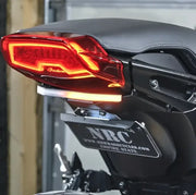 Rear of an Indian FTR 1200 motorcycle with custom-designed fender eliminator featuring a 2-position side mount license plate bracket, highlighting sleek red taillights, surrounded by high-quality RV, automotive, powersports, and off-road accessories.