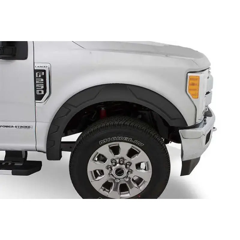 Close-up of a Ford F150 equipped with the FF18-K4560-1 Fab Fours 18 Fd F150 Rnch Fgg, highlighting the vehicle's enhanced rugged front end and Michelin tire.