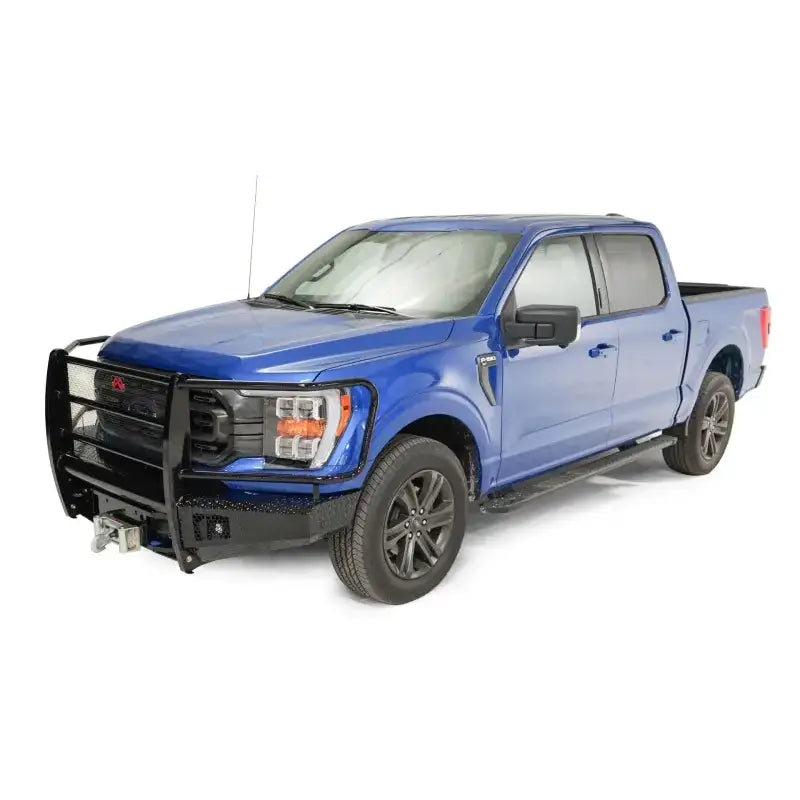 FF21-K5060-1 Fab Fours Elite Series Front Bumper on a blue Ford F-150, showcasing rugged design, high-quality construction, and integrated winch mount for off-road functionality.