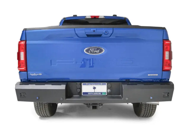 Blue Ford pickup truck with Fab Fours Red steel rear bumper accessory