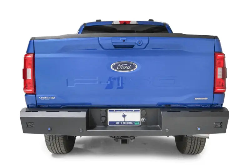 Blue Ford pickup truck with Fab Fours Red steel rear bumper accessory