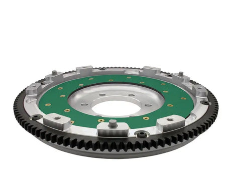 Aluminium flywheel for RX-7’s performance, featuring green friction surface and ring gear