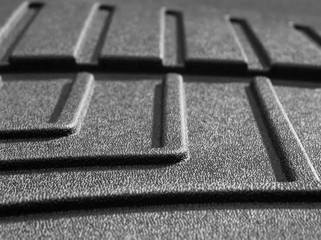 Textured gray thermoplastic polyolefin floor liner molded with channels and reservoir