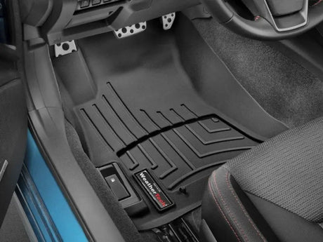 Black WeatherTech floor liner molded fit with channels and reservoir for fluid control