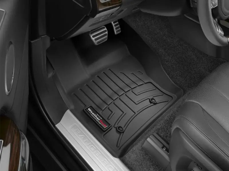 Black floor liner molded with channels and reservoir made from thermoplastic polyolefin