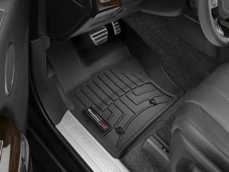 Black floor liner molded with channels and reservoir made from thermoplastic polyolefin