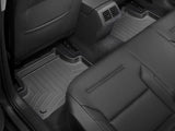 WeatherTech FloorLiner Molded Fit with channels and reservoir for fluid control in black TPO material, rear seat view.