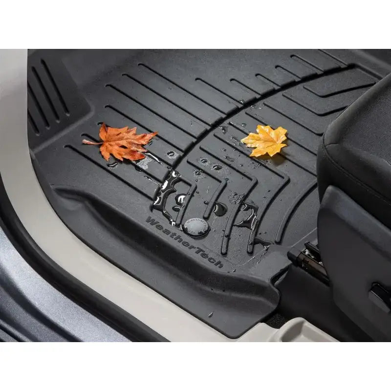 Black thermoplastic polyolefin floor liner with ridges and channels for extra protection