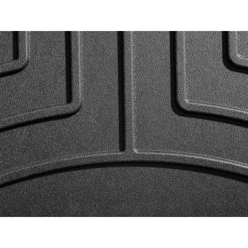 Textured black rubber floor liner molded fit with channels and WeatherTech logo