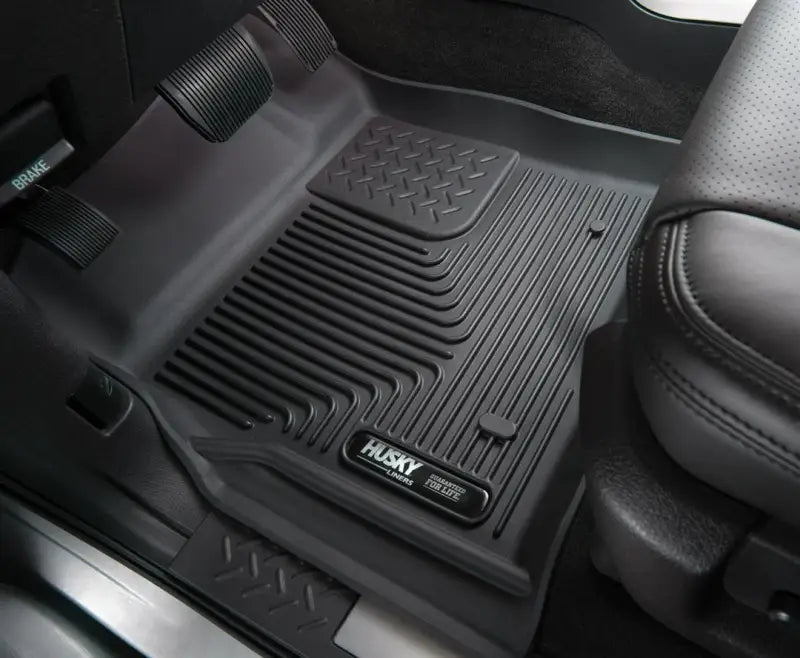 Husky Liners X-act Contour floor liner, molded fit with raised channels and edges, 2-piece black TPE, installed in a vehicle.