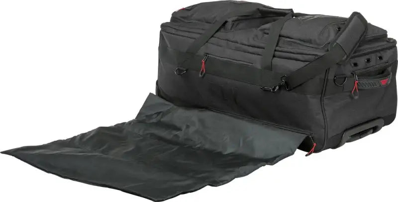 Black fly racing tour roller bag with extended flap, perfect for travel needs