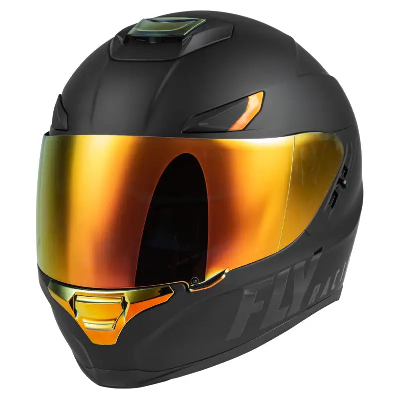 Matte black Fly Racing full-face helmet with gold iridescent visor on helmet tree header