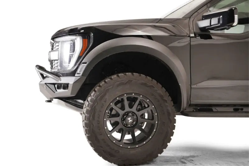 "Front side view of a vehicle fitted with the FR21-D5352-1 Fab Fours Vengeance Front bumper, showcasing its rugged design and superior protection capabilities."