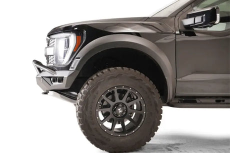 "Front side view of a vehicle fitted with the FR21-D5352-1 Fab Fours Vengeance Front bumper, showcasing its rugged design and superior protection capabilities."