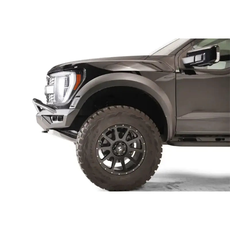 "Front side view of a vehicle fitted with the FR21-D5352-1 Fab Fours Vengeance Front bumper, showcasing its rugged design and superior protection capabilities."