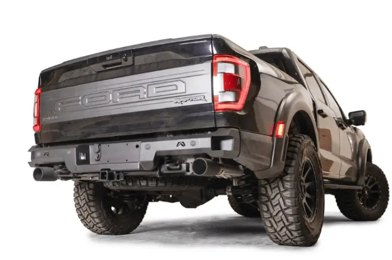 FR21-W5351-1 Fab Fours Premium Rear bumper on a Ford Raptor, showcasing rugged design and off-road readiness.