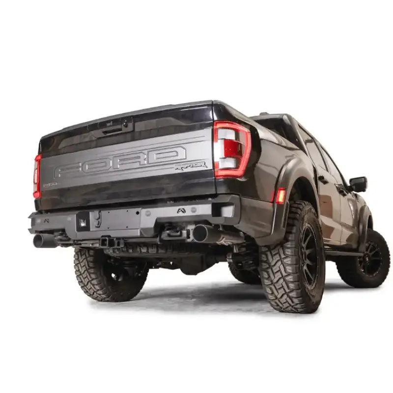 FR21-W5351-1 Fab Fours Premium Rear bumper on a Ford Raptor, showcasing rugged design and off-road readiness.