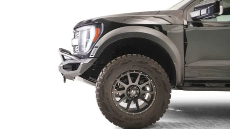 FR21-X5351-1 Fab Fours Matrix Front bumper installed on a rugged off-road vehicle, showcasing durable construction and sleek design, enhancing the vehicle's tough appearance.