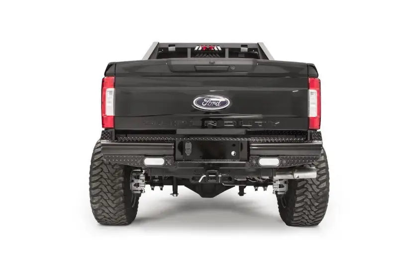 Rear view of a Ford F250 truck equipped with the FS17-T4150-1 Fab Fours rear bumper, showcasing rugged construction and sleek design for enhanced protection and style.