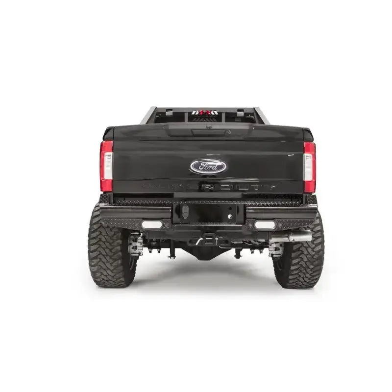 Rear view of a Ford F250 truck equipped with the FS17-T4150-1 Fab Fours rear bumper, showcasing rugged construction and sleek design for enhanced protection and style.
