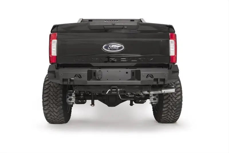 FS17-W4151-1 Fab Fours rear sensor bumper on a Ford F250/F350, showcasing rugged design, integrated sensor openings, and enhanced off-road durability.