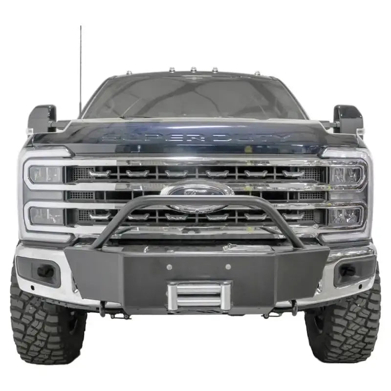 Front view of a vehicle equipped with the FS23-N5960-1 Fab Fours Winch Mount, showcasing its robust and secure off-road mounting solution.