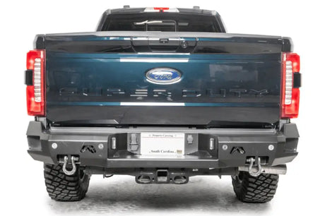 Premium FS23-W5951-1 Fab Fours Rear Bumper on 2023 Ford Super Duty for superior protection and rugged style.
