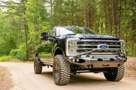 FS23-X5952-1 Fab Fours Matrix Front on a rugged off-road truck in a forest setting, showcasing high-quality construction and aggressive styling for maximum protection, Bumpers, Grilles & Guards, AVADA - Best Sellers, Must Haves