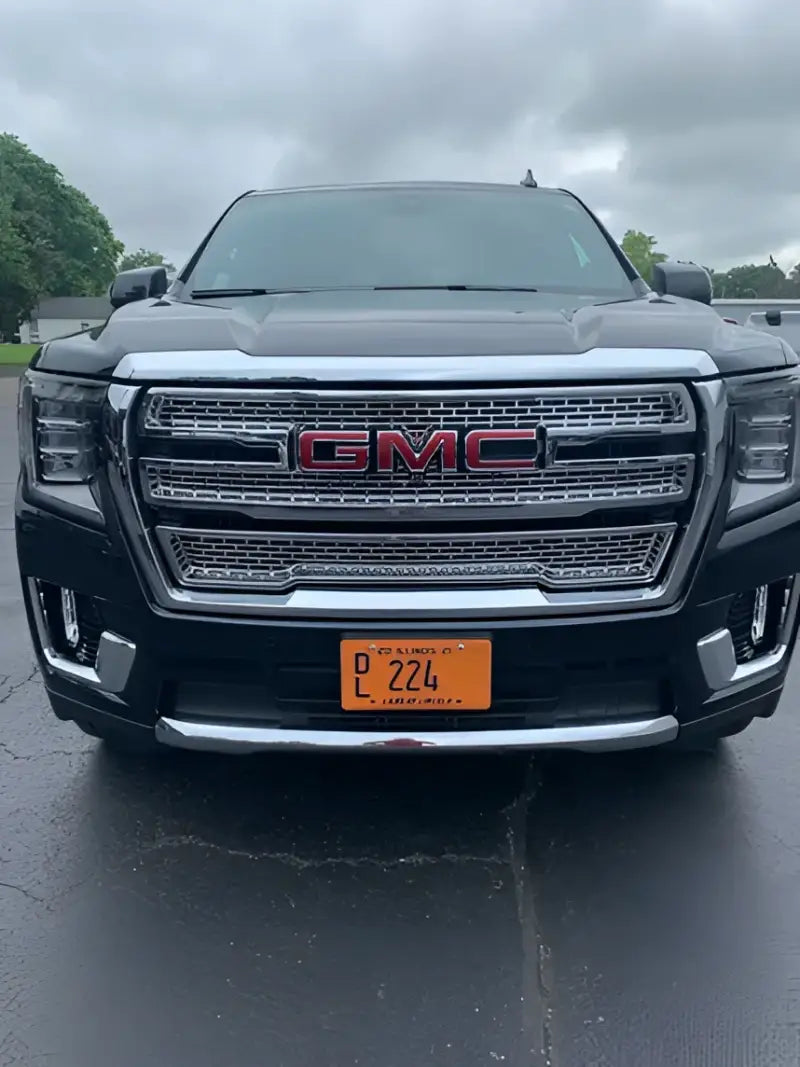 Front view of a GMC Yukon XL showcasing the GI179 Coast2Coast 21-23 Yukon XL chrome grille without camera, with a sleek and modern design for an upgrade in vehicle appearance.