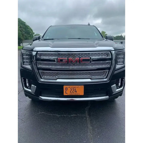 Front view of a GMC Yukon Xl equipped with GI179BLK Coast2Coast Gi glossy black wheel covers, no camera needed.