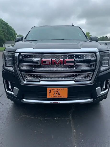 Front view of a black GMC Yukon XL showcasing GI179BLK Coast2Coast glossy black wheel covers, providing a sleek and sophisticated upgrade.