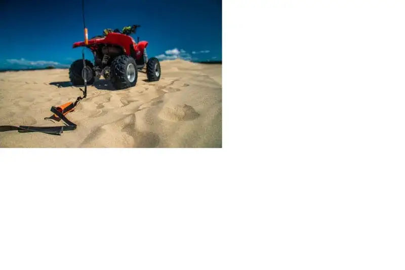 Red all-terrain vehicle with Giant Loop Cordura Ballistic Tow Strap in black
