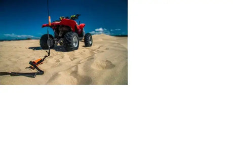 Red all-terrain vehicle with Giant Loop Cordura Ballistic Tow Strap in black