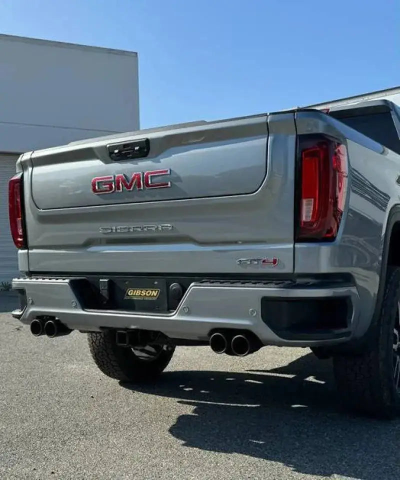 Gray GMC Sierra pickup with Gibson 2024+ active exhaust and stainless steel tips