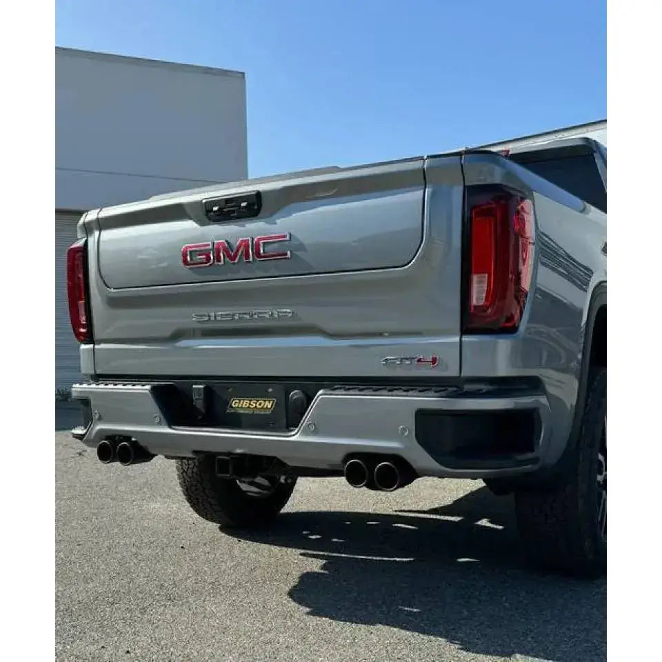 Gray GMC Sierra pickup with Gibson 2024+ active exhaust and stainless steel tips