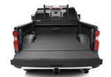 Black powder-coated steel headache rack frame by BACKRACK™, fits truck with or without tonneau cover, installed on blue truck bed.