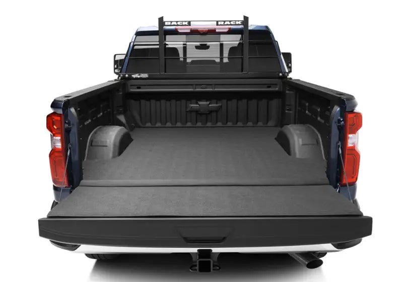 Black powder-coated steel headache rack frame by BACKRACK™, fits truck with or without tonneau cover, installed on blue truck bed.