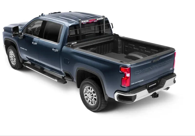 Black powder-coated steel headache rack frame on a blue pickup truck, compatible with tonneau cover, by BackRack.