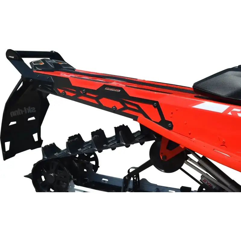 Rear bumper with hidden storage compartment on Red Snowmobile showing black track