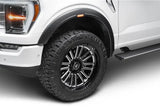 White truck with black fender flares and custom wheels.