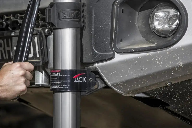 Close-up of ARB Hydraulic Jack lifting a vehicle, highlighting the sturdy build and ergonomic design.