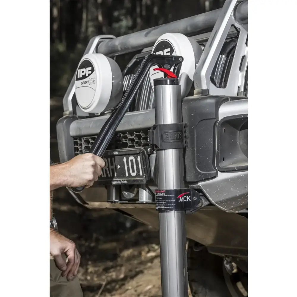 ARB Hydraulic Recovery Jack lifting a vehicle off-road, showcasing its innovative design and hydraulic technology for safe and efficient operation.