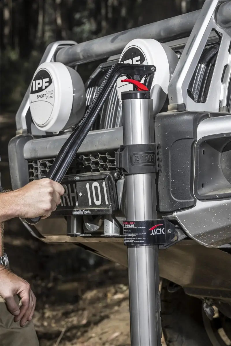 ARB Hydraulic Recovery Jack lifting a vehicle off-road, showcasing its innovative design and hydraulic technology for safe and efficient operation.