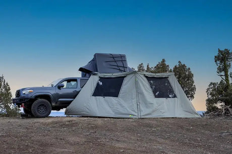 Gray truck with rooftop tent and tent attached showcasing IAWNWALL27034 Ironman 4X4 wall kit