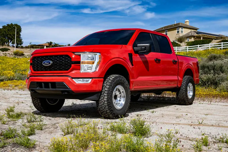 Red Ford F-150 4WD pickup truck with ICON 21-23 F150 4WD 3in coilover kit installed