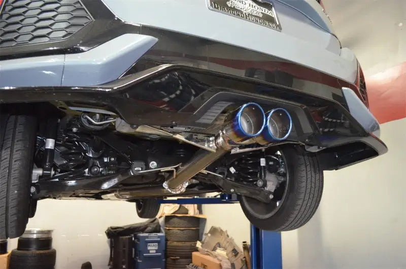 Honda Civic hatchback undercarriage with blue-tipped Injen exhaust for improved sound