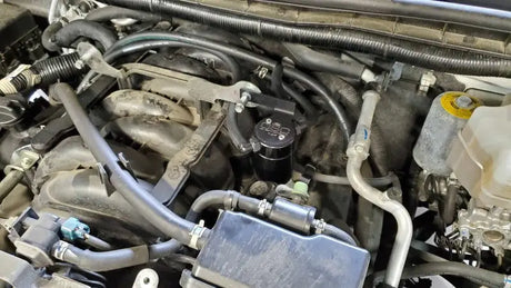 Engine compartment with black catch can oil separator for Nissan Armada J&L upgrade