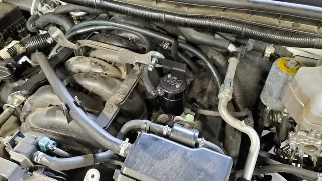 Engine compartment with black catch can oil separator for Nissan Armada J&L upgrade