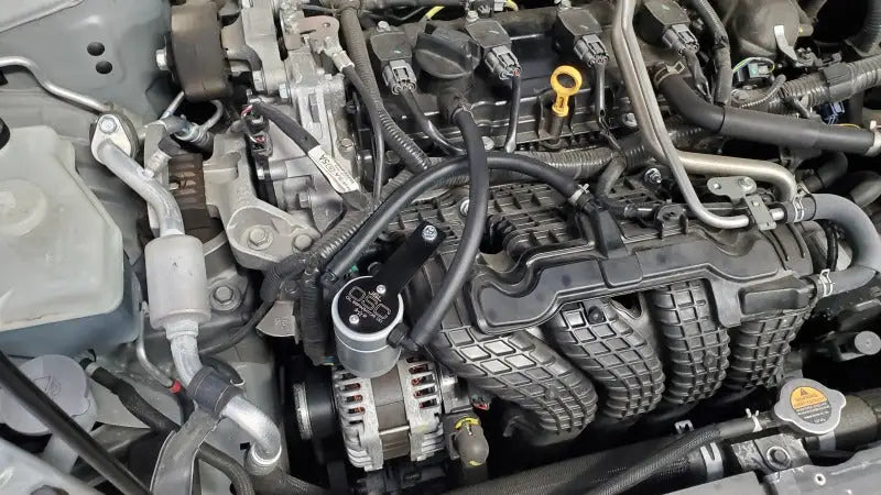 Oil separator for Nissan Altima 2.5L with clear anodized finish on passenger side