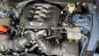 Car engine compartment with J&L 2024 Ford Mustang 5.0L oil separator close-up